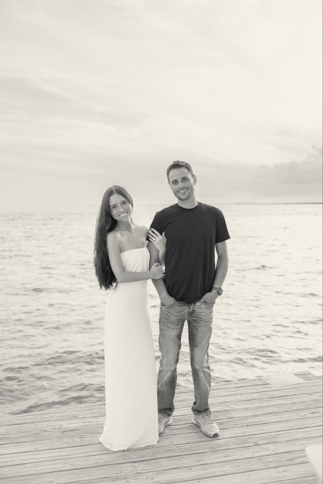 Madison and Jonathan standing together on a dock by the water
